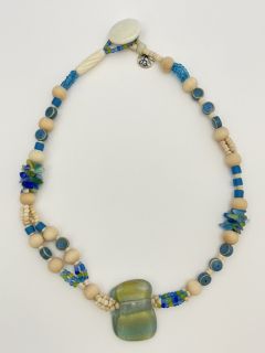 Raw wood, old glass micro beads, ceramic beads, coconut beads.