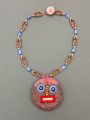 Contemporary designer necklace with an ethnic mask pendant