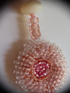 detail of embroidered circle in pink beads